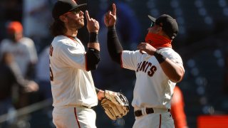 SAN FRANCISCO, CALIFORNIA – APRIL 10: Brandon Crawford #35 and Donovan Solano #7 of the San Francisco Giants congratulate one another after they beat the Colorado Rockies at Oracle Park on April 10, 2021 in San Francisco, California. (Photo by Ezra Shaw/Getty Images)