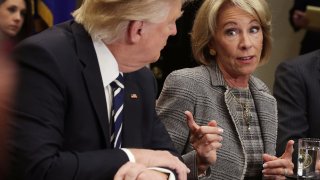 In this file photo, U.S. Secretary of Education Betsy DeVos (R) speaks as President Donald Trump (L) listens during a parent-teacher conference listening session at the Roosevelt Room of the White House February 14, 2017 in Washington, DC.