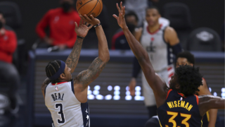 Washington Wizards forward Bradley Beal, left, shoots against Golden State Warriors center James Wiseman during the first half of an NBA basketball game in San Francisco, Friday, April 9, 2021.