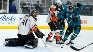 Anaheim Ducks goaltender Anthony Stolarz (41) blocks a shot by San Jose Sharks right wing Kevin Labanc (62) as center Adam Henrique (14) defends during the first period of an NHL hockey game Wednesday, April 14, 2021, in San Jose, California.