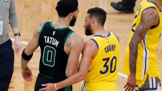 Boston Celtics' Jayson Tatum (0) and Golden State Warriors' Stephen Curry (30) talk following an NBA basketball game, Saturday, April 17, 2021, in Boston.
