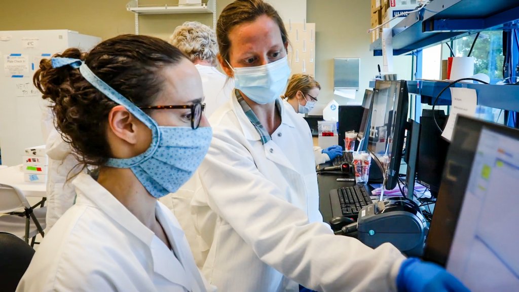 Researchers in a lab look at computers