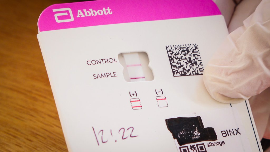 an Abbot coronavirus test card showing a positive result