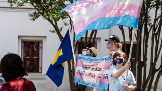 Protestors in support of transgender rights rally outside the Alabama State House in Montgomery, Ala., on Tuesday, March 30, 2021.