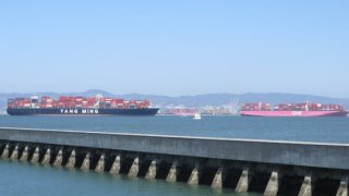 Container ships are lined up on San Francisco Bay waiting to enter the Port of Oakland. (April 10, 2021)