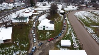 Cars line up to pick up food boxes at the Athens County Fairgrounds in Athens, Ohio, on Dec. 19, 2020.