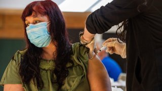 Woman receives COVID-19 vaccine.