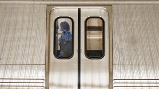 A passenger boards a train at Washington Metro's Dupont Circle station