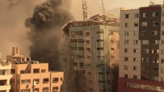 A building housing various international media, including The Associated Press, collapses after an Israeli airstrike