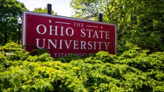 FILE - This May 8, 2019, file photo, shows a sign for Ohio State University in Columbus, Ohio. Ohio State University said Tuesday, Oct. 13, 2020, it will pay $5.8 million to settle lawsuits by about two dozen more survivors over decades-old sexual abuse by a now-deceased team doctor, Richard Strauss.