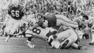 This Jan. 12, 1969 file photo shows New York Jets Pete Lammons (87) getting tackled during the Super Bowl in Miami