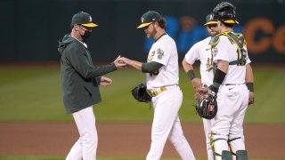 Manager Bob Melvin #6 of the Oakland Athletics takes the ball from pitcher Cole Irvin #19