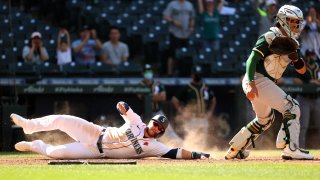 Ty France #23 of the Seattle Mariners scores the game-winning run.