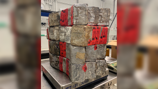 Seized drug bundles containing 132 pounds of methamphetamine on display