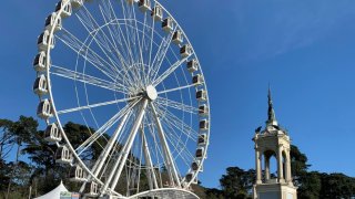 To the right of the SkyStar Observation Wheel in Golden Gate Park’s Music Concourse is the pedestal around which an art installation honoring Black history in America. (Feb. 27, 2021)