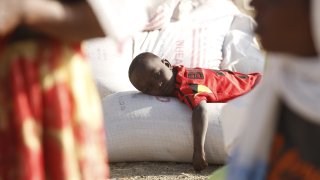 Tigray people, fled due to conflicts and taking shelter in Mekelle city of the Tigray region, in northern Ethiopia, receive the food aid distributed by United States Agency for International Development (USAID) on March 8, 2021.