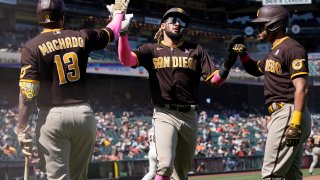 San Diego Padres' Fernando Tatis Jr., middle, and Tommy Pham, right, are congratulated by Manny Machado (13) after both scored on a two-run triple hit by Trent Grisham during the eighth inning of a baseball game against the San Francisco Giants in San Francisco, Sunday, May 9, 2021.