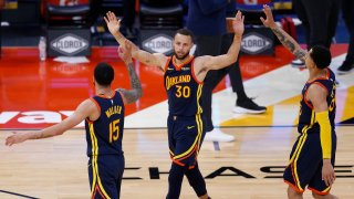 Mychal Mulder, Stephen Curry and Juan Toscano-Anderson of the Golden State Warriors celebrate.