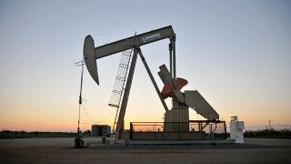 A pump jack operates at a well site leased by Devon Energy Production Co. near Guthrie, Oklahoma.