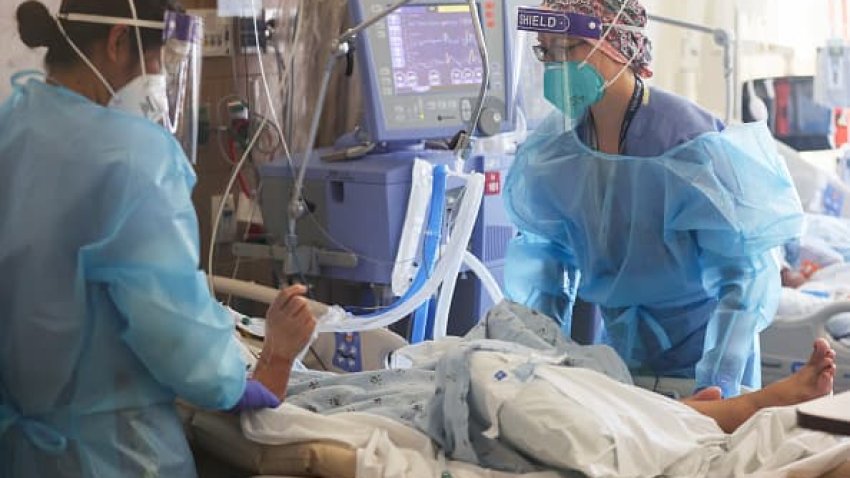 U.S. Air Force 1st Lt. Allyson Black (R), a registered nurse, cares for COVID-19 patients in a makeshift ICU (Intensive Care Unit) at Harbor-UCLA Medical Center on January 21, 2021 in Torrance, California.