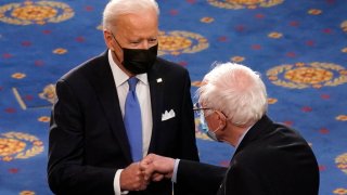 President Joe Biden greets Sen. Bernie Sanders