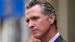 In this June 3, 2021 file photo, California Gov. Gavin Newsom listens to questions during a news conference outside a restaurant in San Francisco. Six weeks after California officials announced that Newsom would face an almost certain recall election, the contest remains framed by uncertainty even the date when it might take place is unclear.