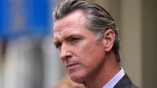 In this June 3, 2021 file photo, California Gov. Gavin Newsom listens to questions during a news conference outside a restaurant in San Francisco. Six weeks after California officials announced that Newsom would face an almost certain recall election, the contest remains framed by uncertainty even the date when it might take place is unclear.