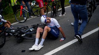 Britain's Chris Froome lays on the road after crashing during the first stage of the Tour de France cycling race