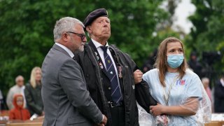 Veterans watch the official opening of the British Normandy Memorial in France via a live feed during a ceremony at the National Memorial Arboretum in Alrewas, Staffordshire.