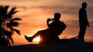 child drinks from a water bottle in Los Angeles, California.