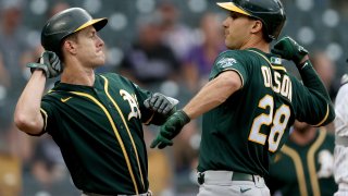 DENVER, COLORADO – JUNE 05: Matt Olson #28 of the Oakland Athletics is congratulated by Mark Canha #20 after hitting a 2 RBI home run against the Colorado Rockies in the first inning at Coors Field on June 05, 2021 in Denver, Colorado. (Photo by Matthew Stockman/Getty Images)