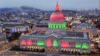 San Francisco City Hall is lit up in the red, green and black colors of the pan-African flag to commemorate Juneteenth on Friday, June 19, 2020, in San Francisco, Calif. as part of ongoing Black Lives Matter protests across the country in the wake of the death of George Floyd.