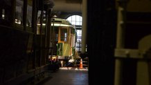 Cable cars sit in the San Francisco's cable barn waiting to resume service. The cars haven't been in service since March 16, 2020.
