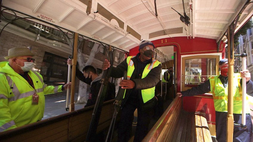 Dwayne Norfleet(center) operates a cable car during a recent train run in San Francisco. San Francisco’s cable car is set to resume in August following sixteen months on hold.