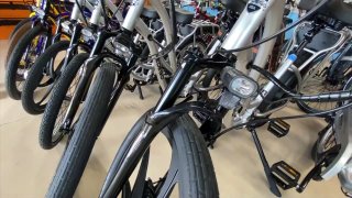 A row of e-bikes in a San Diego shop.