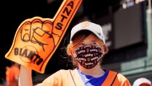 a kid waves a Giants orange foam finger