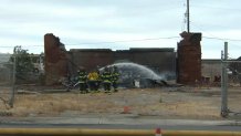 The H.G. Wade Warehouse, a San Jose historic landmark in Alviso, smolders Friday after a fire destroyed it. (June 25, 2021)