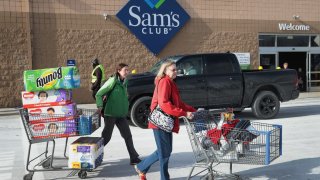 In this Jan. 12, 2018, file photo, shoppers stock up on merchandise at a Sam’s Club store on in Streamwood, Illinois.