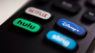 the logos for Netflix, Hulu, Disney Plus and Sling TV are pictured on a remote control in Portland, Ore.