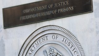 a sign for the Department of Justice Federal Bureau of Prisons is displayed at the Metropolitan Detention Center in the Brooklyn borough of New York