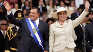FILE - In this Jan. 27, 2010 file photo, wearing the presidential sash, Honduran President Porfirio Lobo and his wife First Lady Rosa Elena wave after Lobo was sworn in as the new president during his inauguration ceremony in Tegucigalpa. The U.S. State Department has named in a report released on Thursday, July 1, 2021 more than 50 current and former officials suspected of corruption or undermining democracy in three Central American countries, including the former Honduran first couple, saying Lobo took bribes from a drug cartel and his wife was involved in fraud and misappropriation of funds. Both deny the allegations.