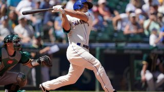 Seattle Mariners' Kyle Seager hits a two-RBI single against the Oakland Athletics during the third inning of a baseball game, Sunday, July 25, 2021, in Seattle.