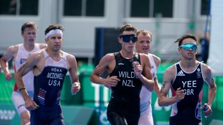 Alex Yee of Great Britain leads a group including Hayden Wilde of New Zealand, center, and Kevin McDowell of United States, left, during the run portion of the men's individual triathlon at the 2020 Olympics on July 26, 2021, in Tokyo, Japan.