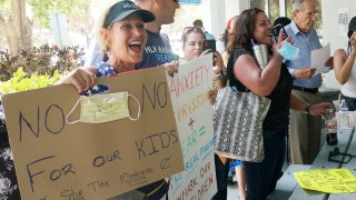 Joann Marcus of Fort Lauderdale, left, cheers as she listens to the Broward School Board's emergency meeting