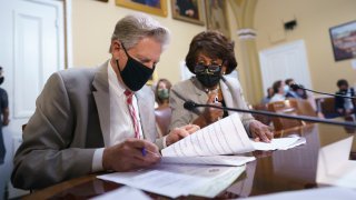 House Energy and Commerce Chairman Frank Pallone, D-N.J., left, and House Financial Services Committee Chairwoman Maxine Waters, D-Calif., go over their notes at the House Rules Committee