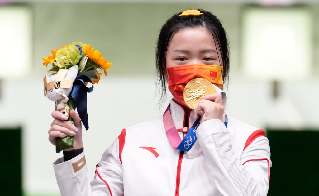 Gold medalist Yang Qian of China celebrates on the podium after the 10m Air Rifle Women's Final on the first day of the Tokyo 2020 Olympic Games at the Asaka Shooting Range on July 24, 2021, Saitama, Japan. Yang was the first to win a gold medal in Tokyo. 