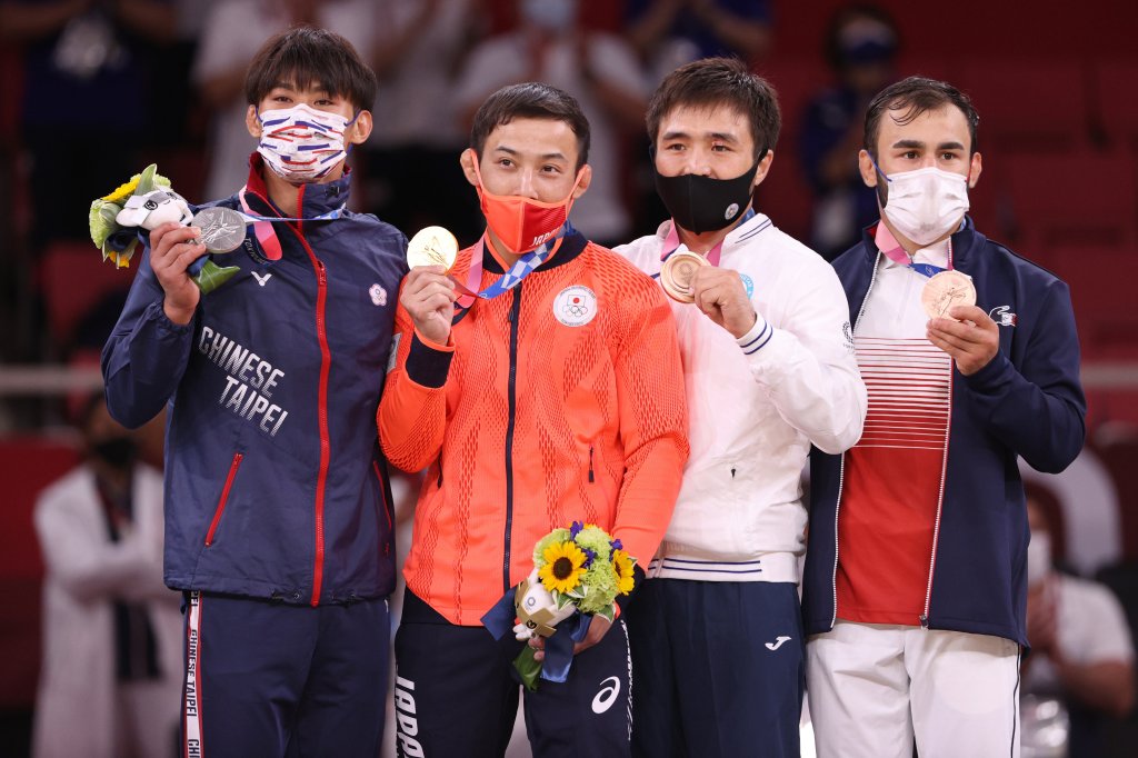 Silver medallist Wei Yung Yang of Chinese Taipei, gold medallist Naohisa Takato of Team Japan, bronze medallist A, Yeldos Smetov of Kazakhstan and bronze medallist B, Luka Mkheidze of Team France pose on the podium for the Men’s Judo 60kg Final on day one of the Tokyo 2020 Olympic Games at Nippon Budokan on July 24, 2021, Tokyo, Japan.