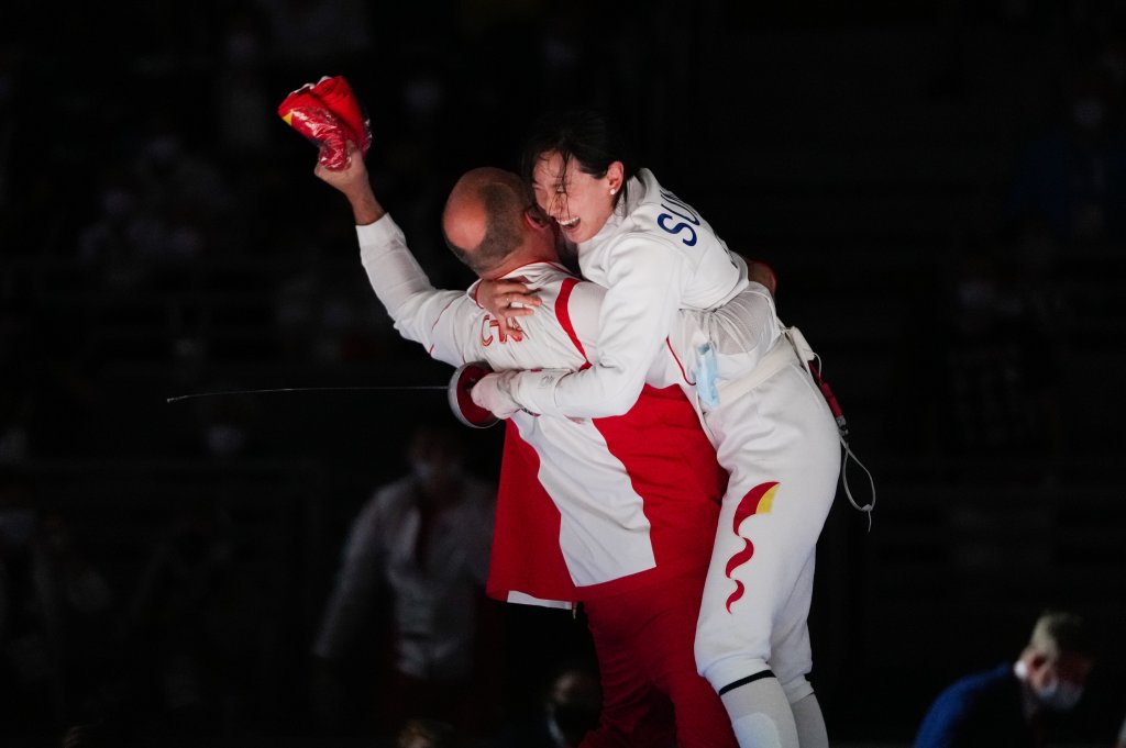 Sun Yiwen of China celebrates with her coach Hugues Obry after winning the Women's Epee Individual gold medal bout of the fencing on day one of the Tokyo 2020 Olympic Games at Makuhari Messe Hall on July 24, 2021, in Chiba, Japan.