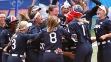Team United States players celebrate with teammate Kelsey Stewart #7 after she hit a walk-off home run to win the game 2-1 against Team Japan during softball opening round on day three of the Tokyo 2020 Olympic Games at Yokohama Baseball Stadium on July 26, 2021 in Yokohama, Kanagawa, Japan.