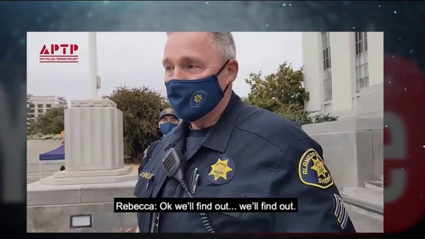 On Tuesday, Sergeant D. Shelby was recorded approaching members of the activist group, Anti-Police Terror Project, who gathered outside an Oakland courthouse to listen to a pre-trial hearing of a former officer charged with manslaughter in San Leandro.